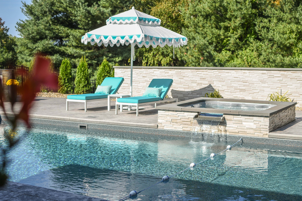 This is a photo of a rectangular pool with a spill-over spa.
